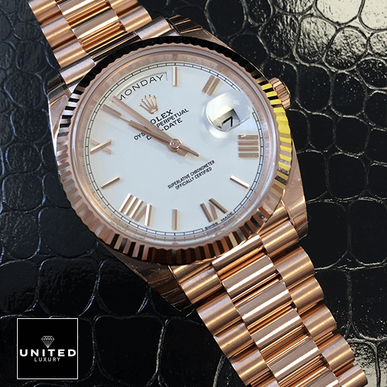 Rolex Day-Date 228235 KW Rose Gold White Dial Replica 5 Rolex Day-Date 228235 Rose Gold Replica on the black leather table